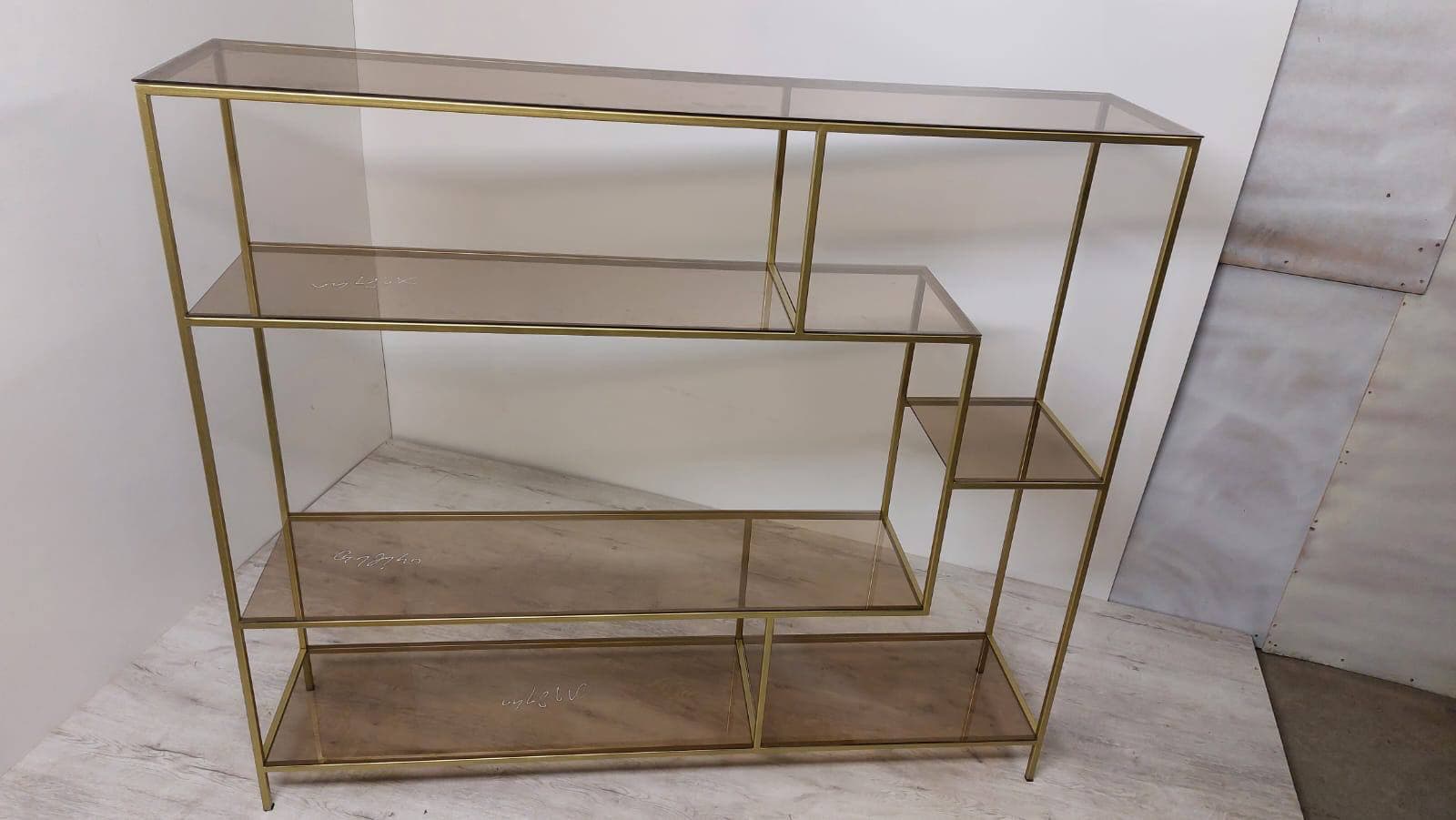 Open console in a warm metal finish